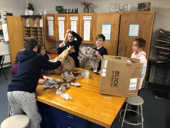 Chance Baez, Matt Murray, Colin McElroy and Beth Mayer work on their art project.