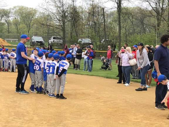 Parents photograph one of the Little League teams.