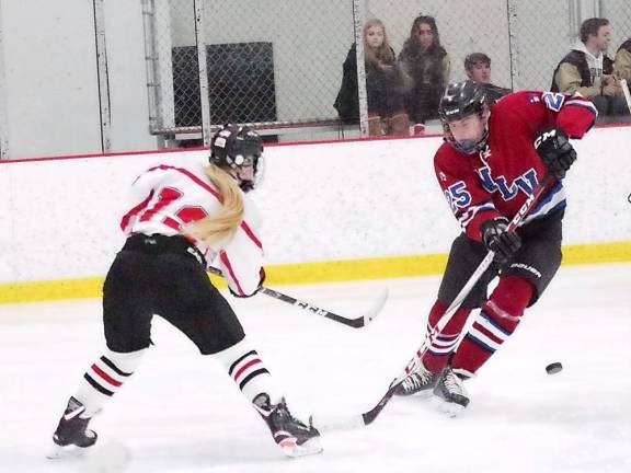 The puck moves through the air after being struck by High Point-Wallkill Valley's Maddy Hennion (long pony tail) in the third period. Hennion provided an assist in the third period.