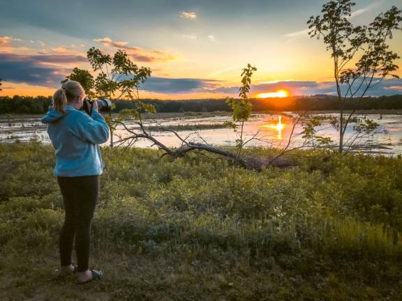 Alayna Vreeland has taken to bird watching during the pandemic, a hobby that keeps her busy well into the winter — here she is photographing a bird.