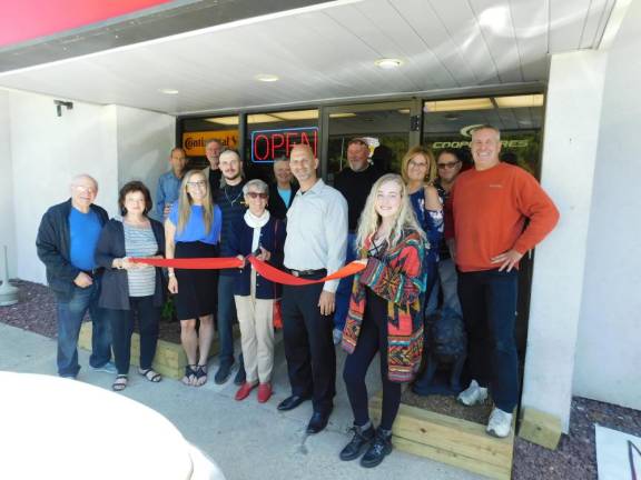 Andover Township Mayor Dolores Blackburn (CL) cuts the ceremonial ribbon for Discount Tire Centers owner Angelo Inglima (CR) who is surrounded by family, friends, and staff.