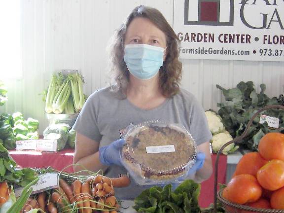 Proposed law seeks fair treatment for farmers selling baked goods at roadside markets Market organizer Donna Traylor displays one of the delicious pies at the Sussex County Fairground Farmers Market last summer (Photo by Janet Redyke)