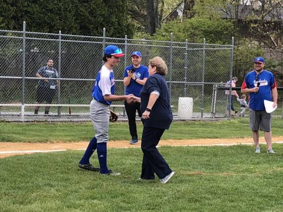 Stanhope Mayor Patricia Zdichocki shakes hands with the catcher after the first pitch.