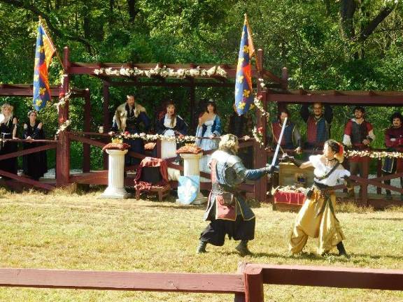 Knights and faeries roman the woods of Sparta King James, Queen Misha, and their royal court look on while challengers engage in swordplay