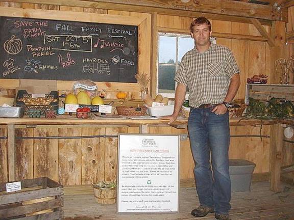 Jason Touw at his popular farm stand at Wagon Wheel Farm on Sarah Wells Trail in the Town of Goshen. The farm sells fresh picked vegetables, pumpkins, and eggs.