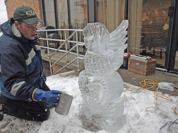 Cutting the ice A splash of water adds polish and shine to the sculpture.