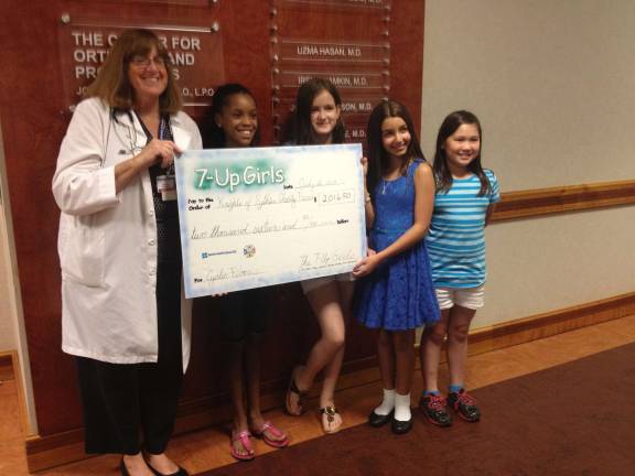 7-Up girls donate $2,000 to Cystic Fibrosis Dr. Dorothy Bisberg, and 7-Up Girls Madisyn P., Isabella T., Audrey S. and Jillian C.