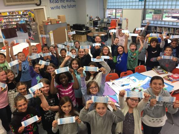 School kids inspired by 'Wonder' and kindness Helen Morgan Kindness Ambassadors flash their Golden Tickets to a special screening of “Wonder."