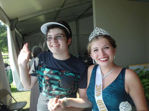 2016 Queen of the Fair Kelly Wask (right) in her regalia, with a well-wishing friend
