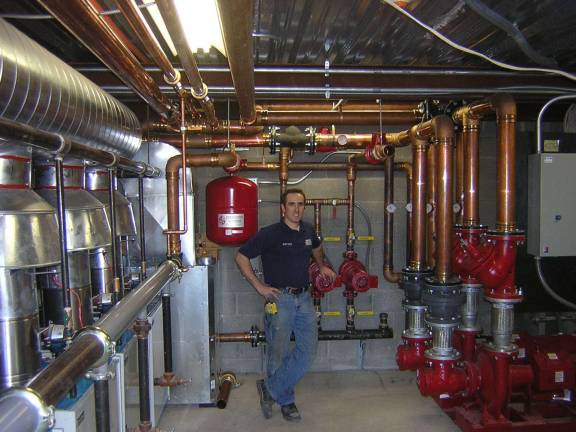 Perfection Contracting owner and CEO Antonio Poccio in the basement of Branchville Manor after an installation.