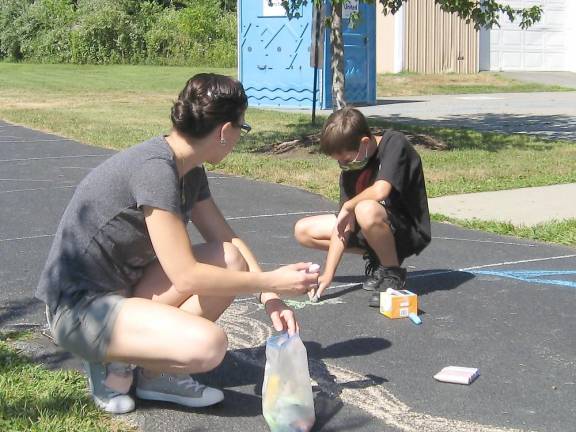 Lasorsa family members work on their colorful designs (Photo by Janet Redyke)