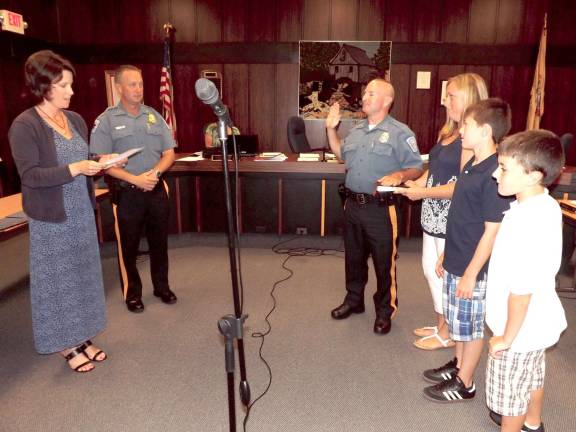 Byram Police Department Holds Awards Ceremony Deputy Mayor Marie Raffay swears in Patrolman Lawrence Mendelsohn as the newest officer of the Byram Township Police Department. Patrolman Mendelsohn's wife holds the Bible as their sons stand with them. Next to Deputy Mayor Raffay is Byram Police Chief Ray Rafferty.