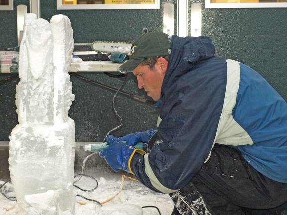 Cutting the ice Chad Gasiorek, culinary arts instructor, uses a die grinder to carve details in an ice sculpture Thursday morning.