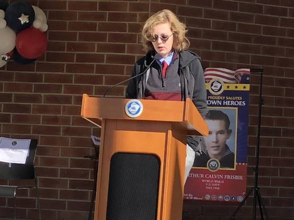 NV4 Evan Hutchens, a student at Halsted Middle School, reads his essay about veterans. He won Newton’s essay contest.