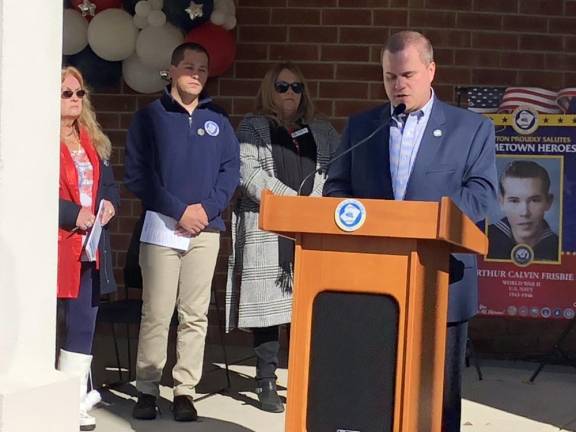 Newton Town Manager Thomas Russo Jr., at podium, said Newton will start a Hometown Heroes banner program next year. A sample banner is behind him.