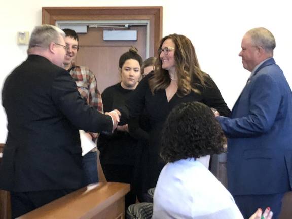 State Sen. Steve Oroho, R-24, congratulates Jill Space after he administers the oath of office to her as director of the Sussex County Board of County Commissioners. At right is Space’s husband, Parker, who will succeed Oroho in the state Senate on Tuesday, Jan. 9.