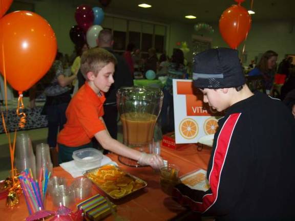 They mean business Griffin Jennings, 11, owner of Griffin's Vita C Tea serves a customer.