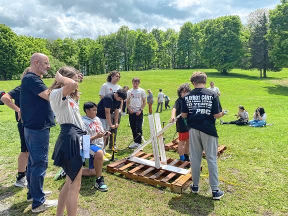 Students build water rockets Hardyston Middle School competitors and high school assistants, from left, Emily Guarino, Isaiah Gutierrez, Kaleb Billegas, John Ozdemir, Noah DeRenzo, Jovanni Portilla and Alekos Reinlee prepare their launcher for final testing.