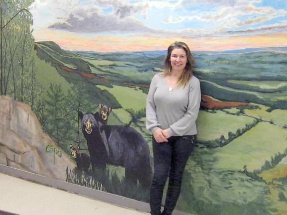 Kim Esposito with her Stairway to Heaven mural, which includes native fauna like the family of black bear depicted (Photo by Janet Redyke)