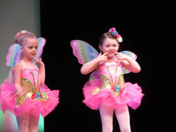 D'Marge dancers welcome summer with recital Savannah Norman and a fellow "butterfly" on stage.