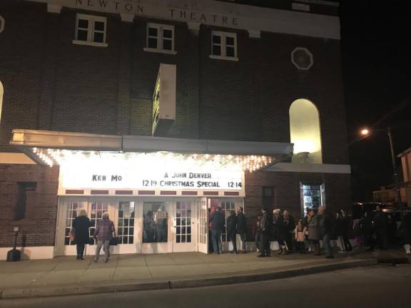 Friends and family wait on line to gain entrance to The Newton Theatre for a performance of Elf Jr.