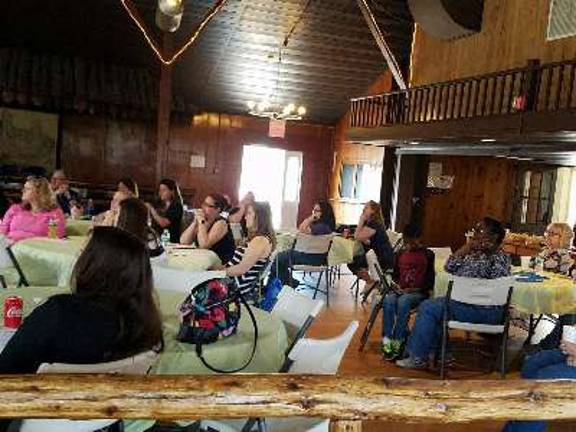 The audience watches a video as part of the presentation at the Barn at Hillside Park on Saturday.