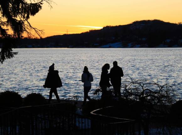 The cold Lake Mohawk sunset is appreciated by attendees of the Christmas Market on Saturday.