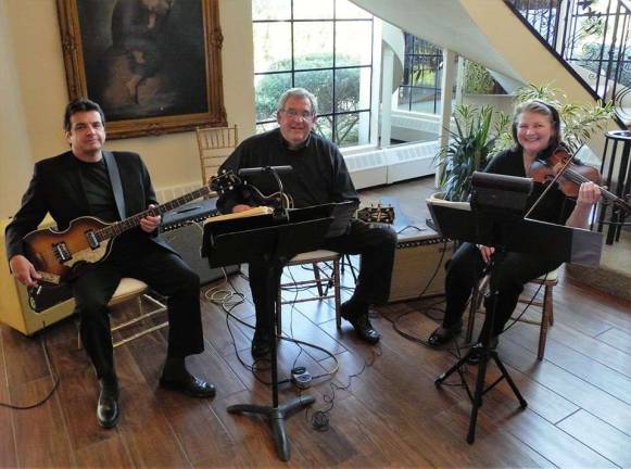 Renowned chefs and eclectic cuisine benefit Project Self-Sufficiency Gary Kraemer (center), his wife Carole (right) and their friend Michael De Maio formed one of the musical ensembles performing at the event.