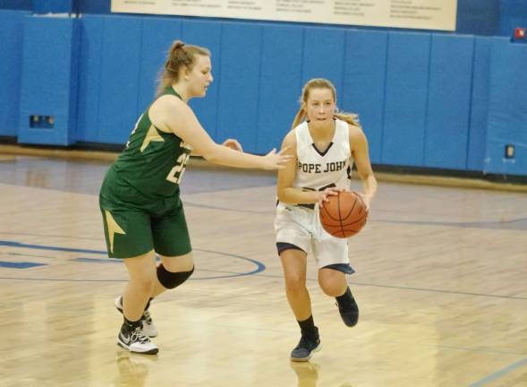 Pope John's Marissa Radics handles the ball while covered by Sussex Tech's Peyton Kinney in the fourth period.