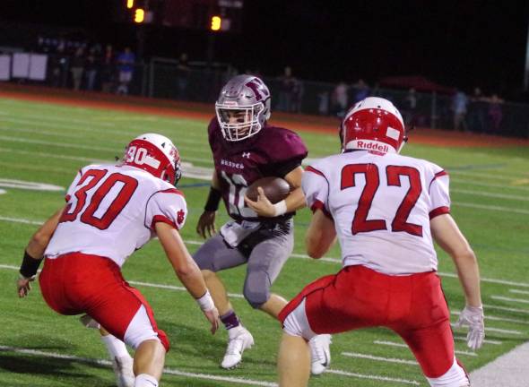 Newton Braves keep rolling In the first quarter after running to the outside on a keeper Newton's Michael Freda faces two Whippany Park defenders.