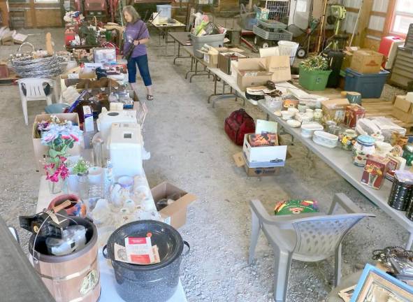 Snufftown Garden Club to raise funds for Blue Star Memorial Highway Marker Snufftown Garden Club President Rose Wolverton looks over some of the many donations from Snufftown members that will be available at the yard sale.