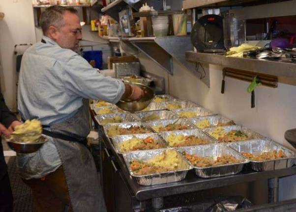 Local merchants, volunteers give back for Thanksgiving Brad Boyle at work in the kitchen.