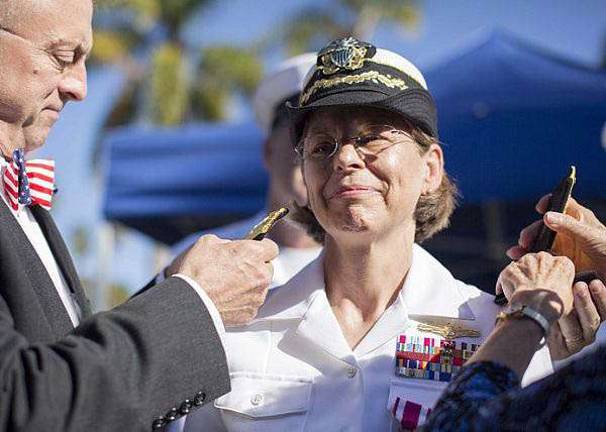 Lafayette local promoted to Rear Admiral U.S. Navy photo by Mass Communication Specialist 3rd Class Gregory A. Harden II/Released Rear Adm. Linnea J. Sommer-Weddington receives her rear admiral shoulder boards from her husband, Andy Weddington, at her promotion ceremony. Sommer-Weddington is the first female reserve officer to carry one star on her shoulder boards within the Information Dominance Warfare community.