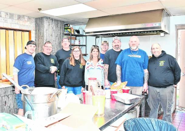 The crew prepares breakfast at Branchville Hose Company #1.