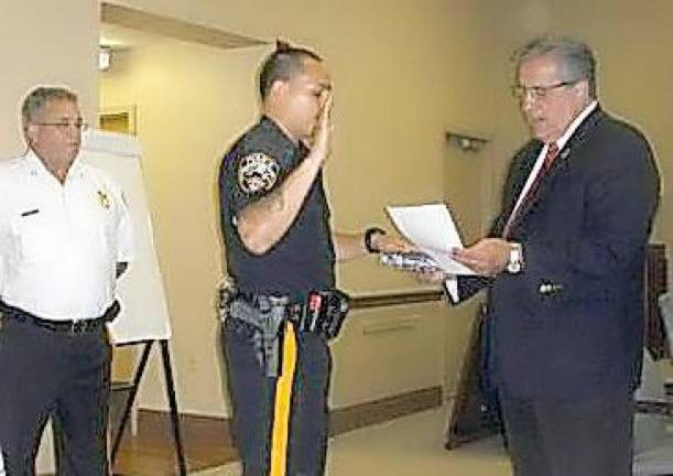 Suspended police officer faces prison time in offered plea deal Then-Mayor Vic Marotta swears in Patrolman Emanuel Rivera at an August 2013 township council meeting as Chief Roy Wherry looks on. (File photo by Mike Zummo)