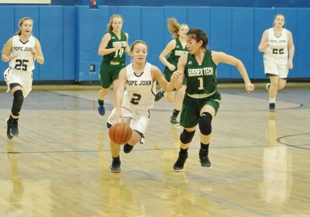 Pope John's Aura Rispoli dribbles the ball while Sussex Tech's Marissa Munoz keeps pace during a fast break.