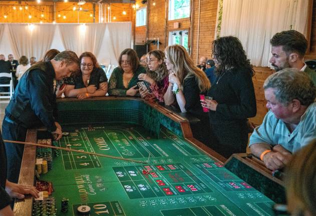 Photos: Casino Night fundraiser <b>The craps table is popular with those trying their luck Thursday, May 22.</b>