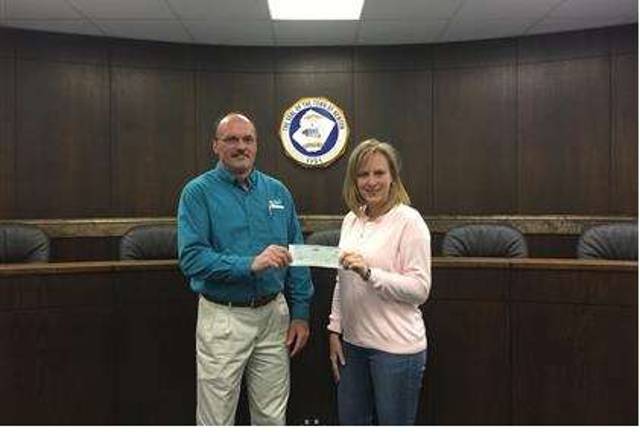 McKee honors Drake with a gift to Newton McKee Foods' Sam Stillings presents a $20,000 check to Newton Recreation Supervisor Debbie Danielson.