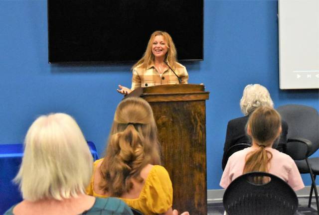 Ann Arnold pays tribute to her father, Mark Schowetter, who survived the Holocaust, at the opening ceremony of the Holocaust and Genocide Research Center.