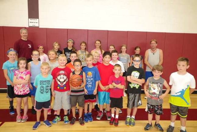 Basketball players learn skills at camp Basketball coaches Mitch Hillard and Keith Anderson and participants pose for a portrait on the final day of basketball camp Friday, Aug. 1.
