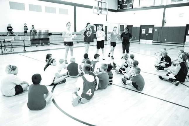 Basketball players learn skills at camp Far left Newton High School head varsity girls basketball coach Whitney Dugan addresses camp participants.