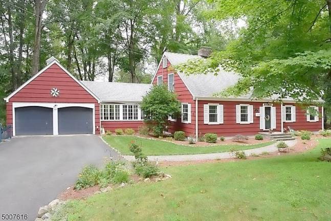 Four-bedroom colonial is nestled in a parklike setting