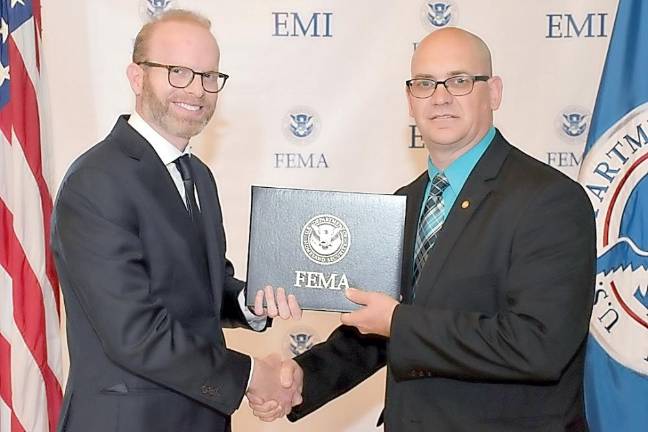 Vogel completes FEMA course Corporal Mark Vogel, right, accepts his certificate from Dr. Daniel Kankiewski of the Federal Emergency Management Agency.