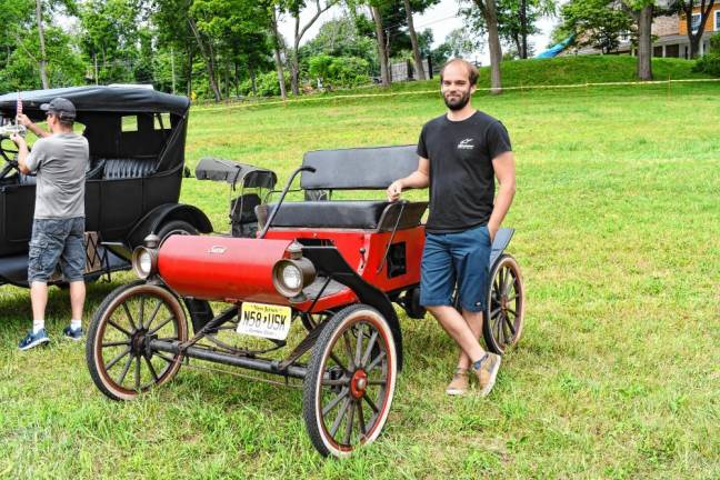 Cars & Guitars Party Eric Redding of Hampton Township stands by his red and black Surrey car.