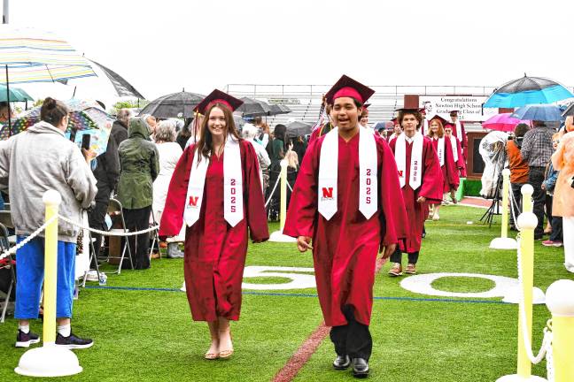 Photos: Newton High School graduation Graduates walk into the ceremony in the rain.