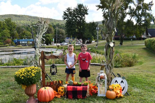 Upcoming fall festivals <b>Dougie Morrica and Conner Minter of Vernon pose in front of a fall display at the Vernon Street Fair on Saturday, Sept. 13. (Photo by Maria Kovic)</b>
