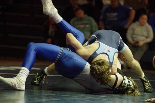 A Spartan, top, and a Kittatinny Cougar grapple on the mat on Jan. 26.