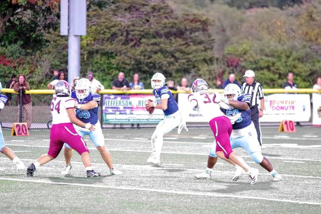 Football roundup: High Point remains undefeated <b>Sparta quarterback Shane Hoover holds the ball as he scans the field for an open receiver. He threw for 253 yards.</b>