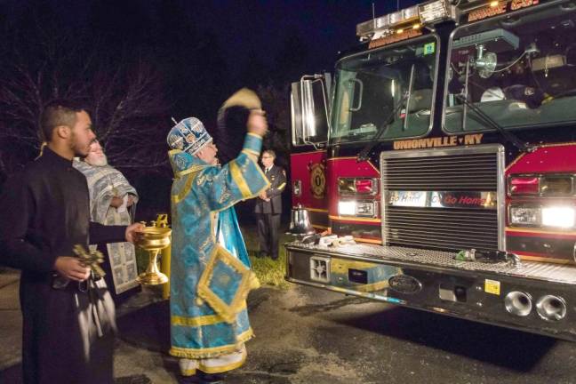 Archbishop Michael of New York and New Jersey blesses a firetruck (Photo by Cheryl Fleishman)