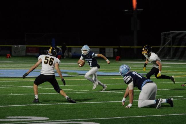 Sparta quarterback Shane Hoover on the run. He threw the ball for a total of 298 yards resulting in five touchdowns. He also kicked four points after touchdowns.